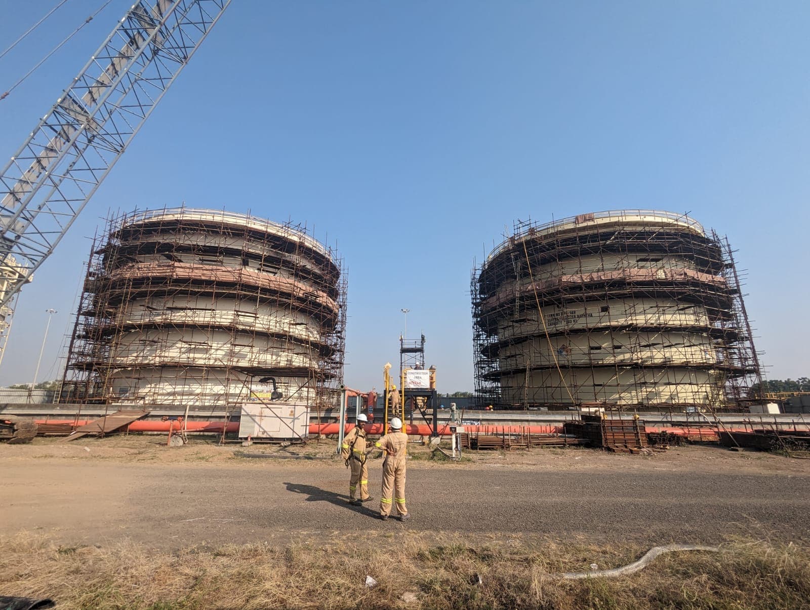 The twin ethanol storage tanks under construction in scaffolding for the Reliance E20 project, with the site crew in front