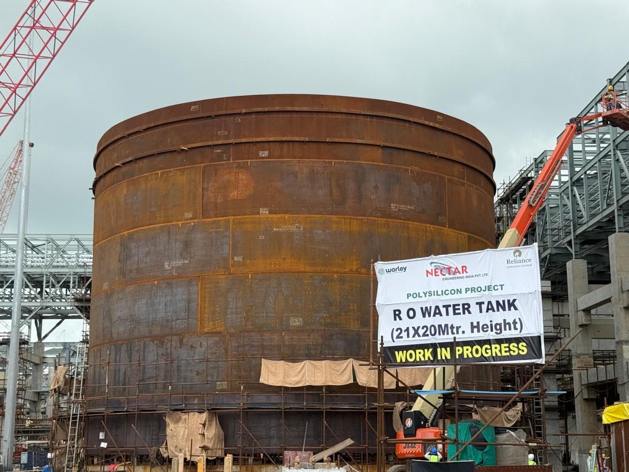 The RO water tank under construction on the Reliance polysilicon project, with the Nectar Engineering site banner