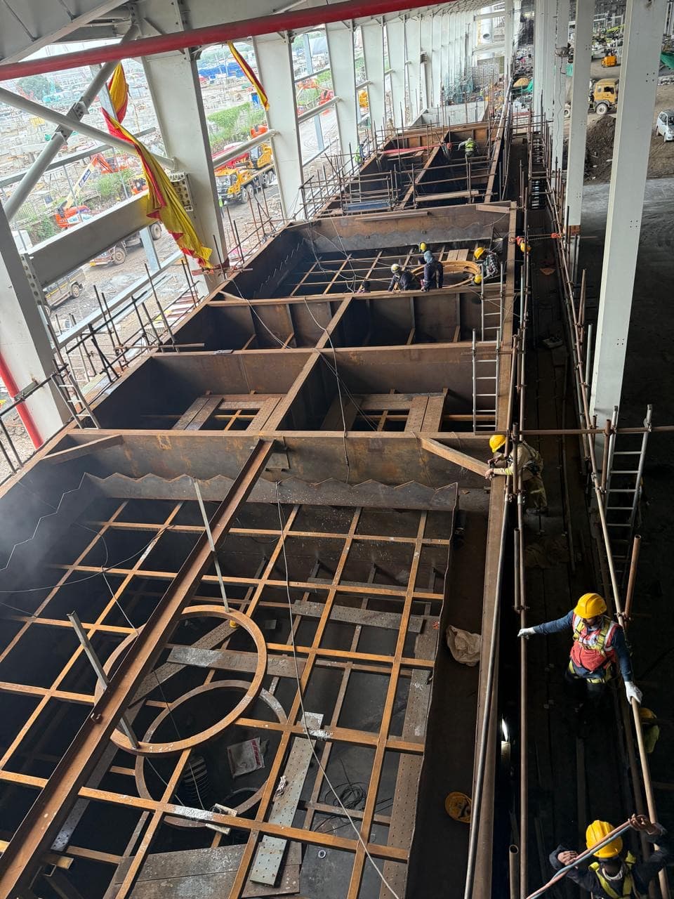 A site-fabricated water-treatment-plant tank (air-flotation / sedimentation) for the Reliance glass factory, with the crew working across the assembly