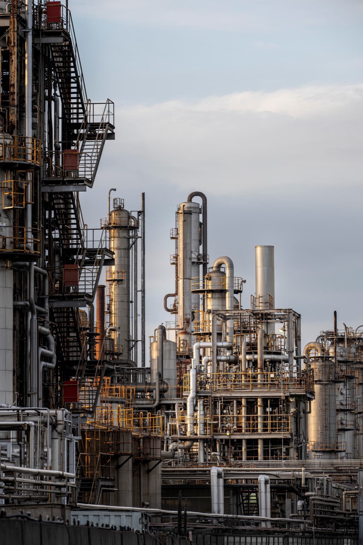 Refinery process columns and pipework at golden hour